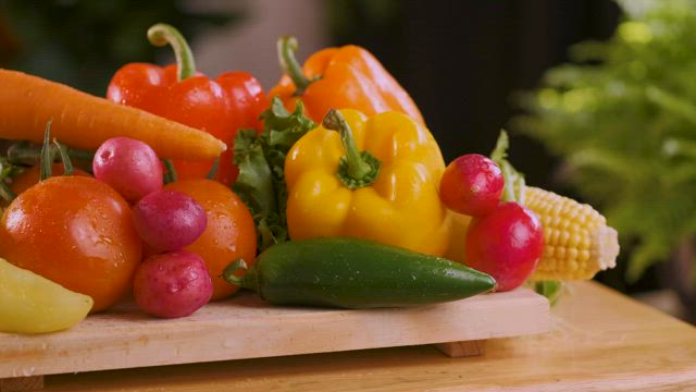 Fresh vegetables on a wooden board close up view.