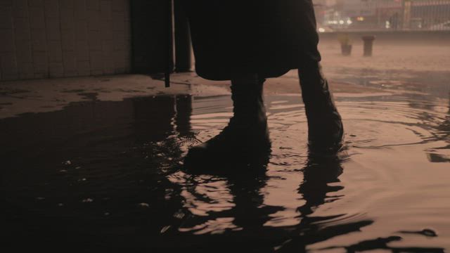 Zombie walking in a puddle .