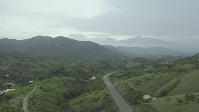 Road surrounded by mountains .