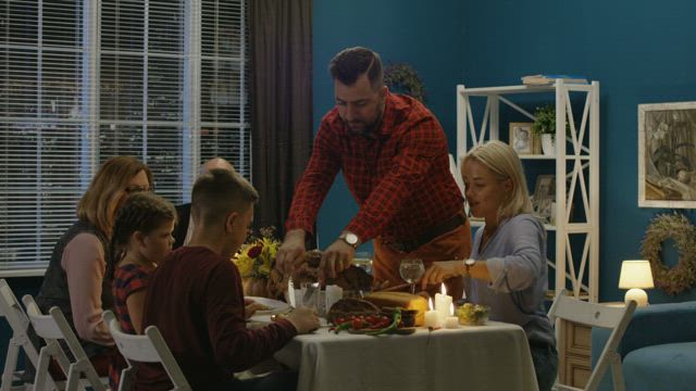 Man serving the turkey for his family.