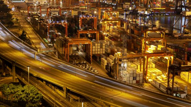 Large container area working at night.