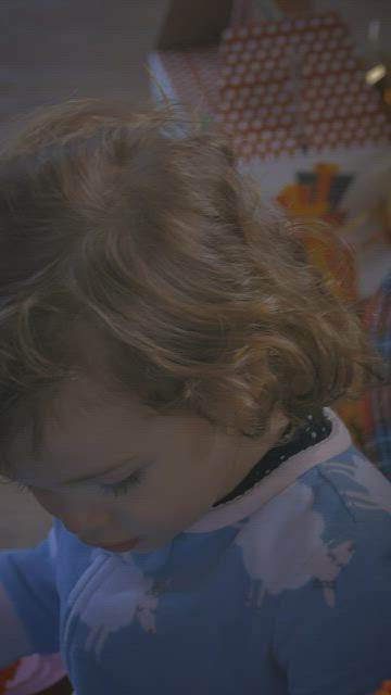 Little girl and her father playing with toys at Christmas.