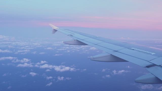 Pink sunset seen from a plane window.