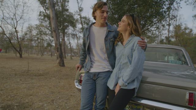 Boy and girl talking on a road trip through nature.