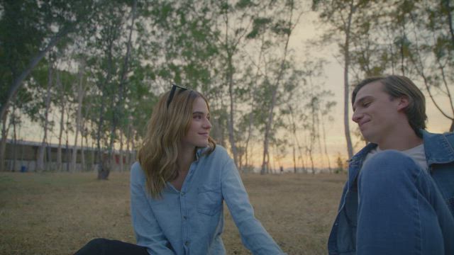 Couple talking in a forest.