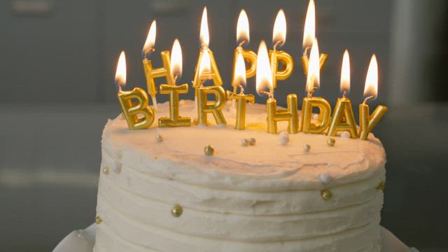 Cake with letter candles that say Happy Birthday.