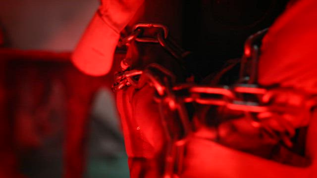 Close up of chains binding a torture victim.