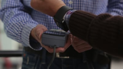 Man is Paying with a Smart Watch.