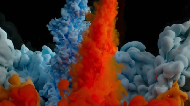 Vibrant colored inks interacting with a black liquid creating flowing clouds in a mesmerizing motion spectacle.