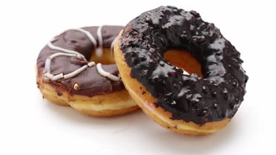 Chocolate donuts on a white background.