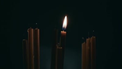 Lit One Candle in a Dark Room, Next To Not Lit Candles.