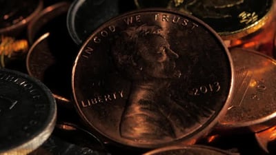 Coins in a Dark Room Shines From Them Falling on the Light. Close Up.