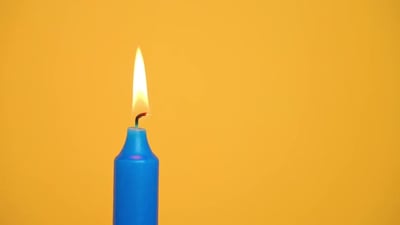 Blue Candle With Lit Candle Stick.