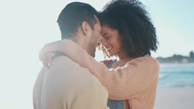 Couple, forehead touch and beach with happiness and travel, love and romance.