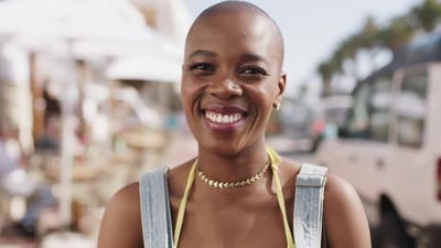 Face, smile and cheerful black woman enjoying summer vacation outside while laughing with joy.