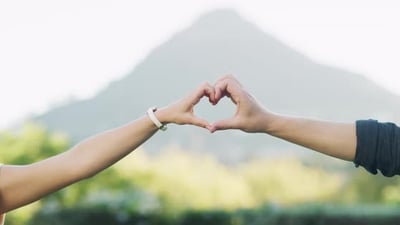 Nature, love and couple hands in heart for bonding, romance and loving emoji gesture outdoors.