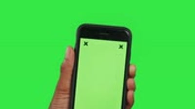 Hands, phone and mockup green screen with tracking markers for advertising against a studio.